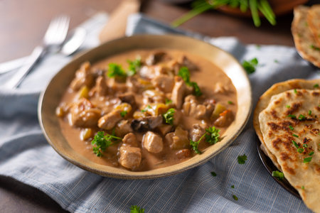 Tikka masala with herbs and homemade naan breadの写真素材