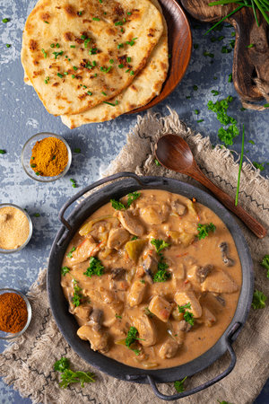 Tikka masala with herbs and homemade naan breadの写真素材