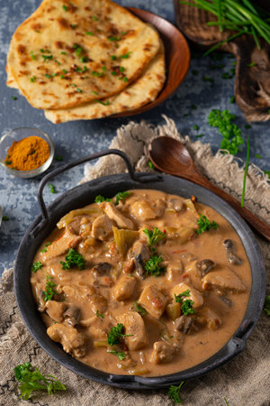 Tikka masala with herbs and homemade naan breadの写真素材