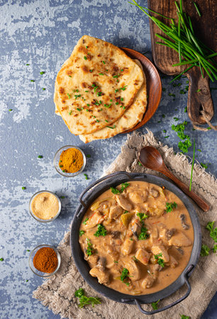 Tikka masala with herbs and homemade naan breadの写真素材