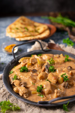 Tikka masala with herbs and homemade naan breadの写真素材