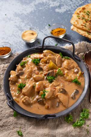 Tikka masala with herbs and homemade naan breadの写真素材