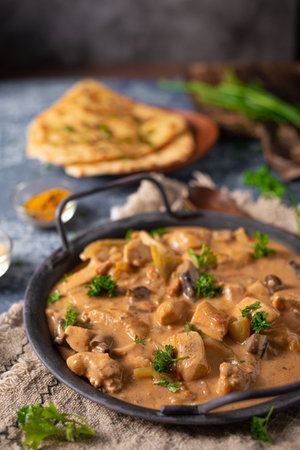 Tikka masala with herbs and homemade naan breadの写真素材