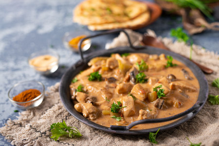 Tikka masala with herbs and homemade naan breadの写真素材