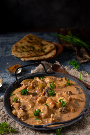 Tikka masala with herbs and homemade naan breadの写真素材