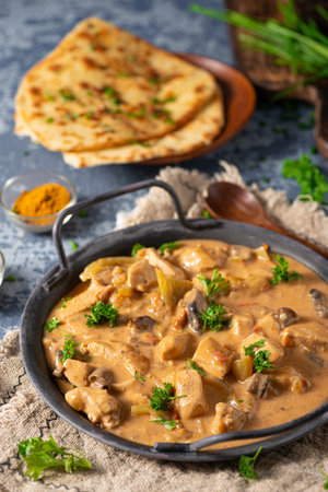 Tikka masala with herbs and homemade naan breadの写真素材