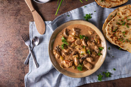 Tikka masala with herbs and homemade naan breadの写真素材
