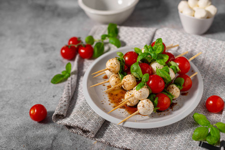 Simple and beautiful food with basil, mozzarella and balsamic vinegarの写真素材