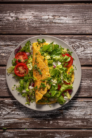 Delicious eggs omelette with salad and vegetablesの写真素材