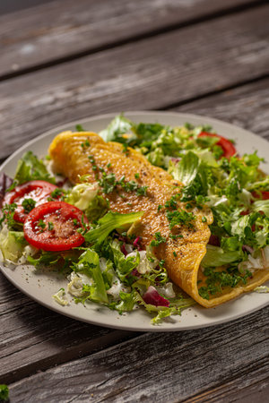 Delicious eggs omelette with salad and vegetablesの写真素材