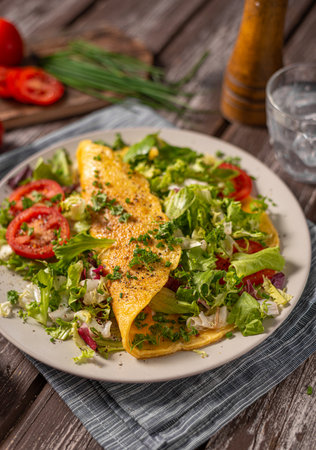 Delicious eggs omelette with salad and vegetablesの写真素材