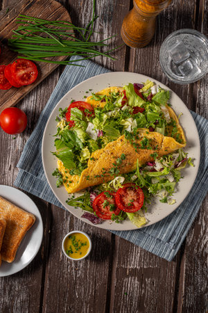Delicious eggs omelette with salad and vegetablesの写真素材