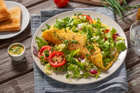Delicious eggs omelette with salad and vegetablesの写真素材