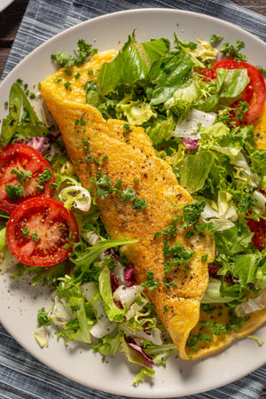 Delicious eggs omelette with salad and vegetablesの写真素材