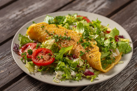 Delicious eggs omelette with salad and vegetablesの写真素材