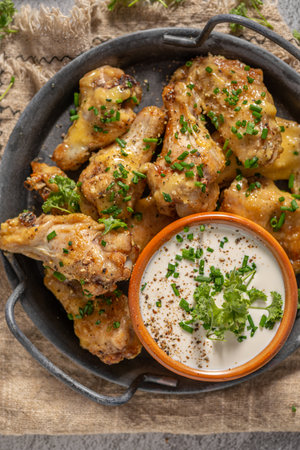Delicious chicken wings with parmesan mayo and garlic dippingの写真素材