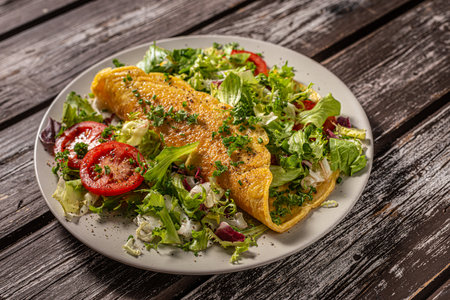 Delicious eggs omelette with salad and vegetablesの写真素材