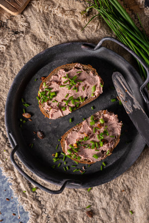 Bio organic pate with herbs and garlic, spread on breadの写真素材