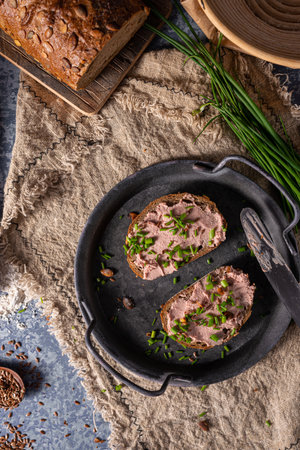 Bio organic pate with herbs and garlic, spread on breadの写真素材