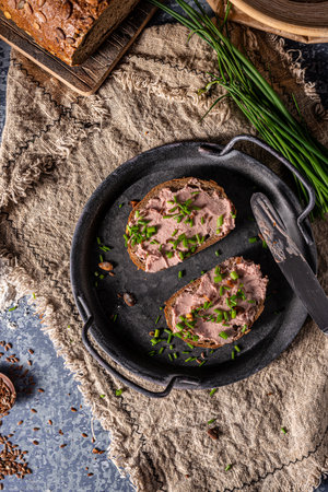 Bio organic pate with herbs and garlic, spread on breadの写真素材