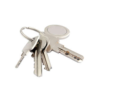 A set of four keys of various types with metal keyring and fobの写真素材