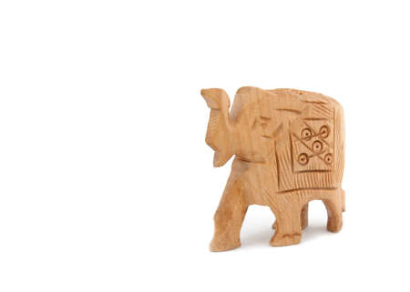 A small roughly carved wooden elephant isolated on whiteの写真素材