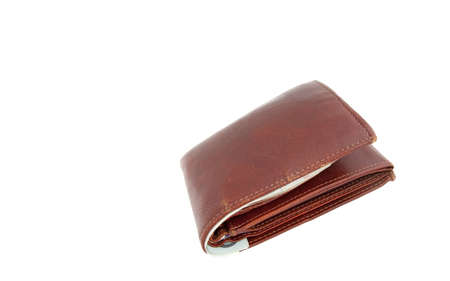A closed brown leather wallet with bank notes visibleの写真素材