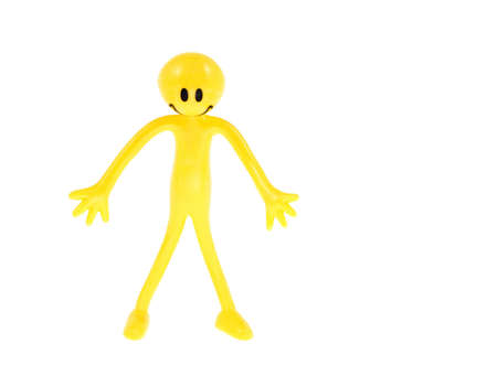 A yellow flexible plastic figure with smiley faceの写真素材