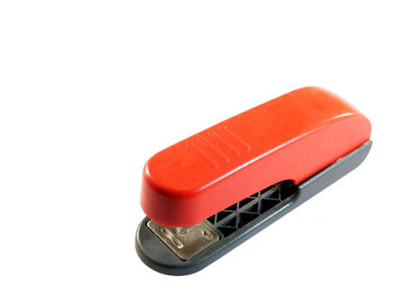 A large red stapler isolated on a white backgroundの写真素材