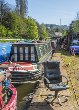 An office chair dumped alongside a canal in Yorkshireの写真素材
