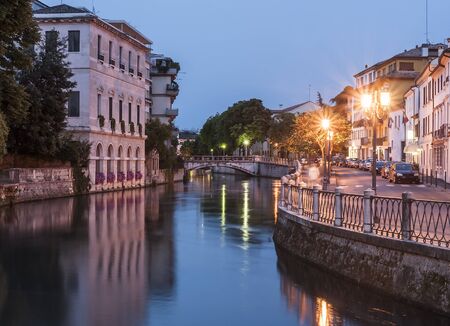 Early evening along the banks of the river sile in the Veneto town of Treviso in northern Italyの写真素材