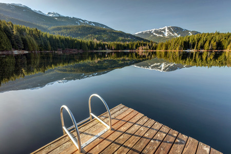 Early morning sunlight on the dock at Lost Lake in Whistler, British Columbia, Canadaの写真素材