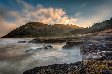 The very scenic Cape Perpetua on the Oregon Coast. Long exposure of waves crashing on the shore at sunrise.の写真素材