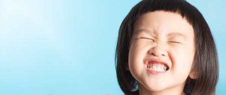Cute asian girls show happiness. In various postures on a blue background with copy space.
