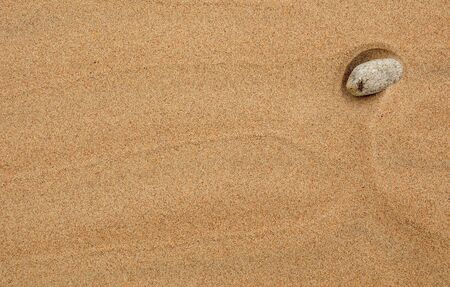 Sand background with stone の写真素材