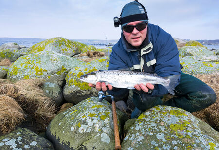 Men with silver sea trout trophy