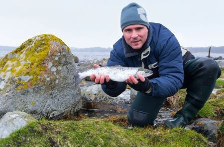 Men with sea trout fishing trophy
