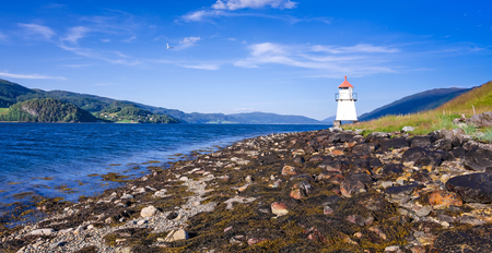 Lighthouse on Norwegian summer coastの写真素材