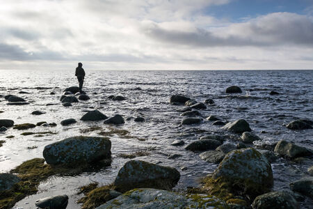 Man fishing alone in the spring seaの写真素材