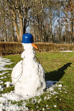 Melting snowman in home gardenの写真素材
