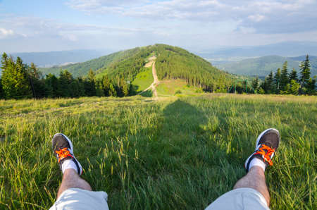 Man relaxing on the mountain topの写真素材