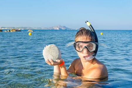 Snorkeling girl with her findの写真素材