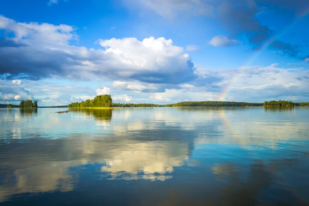 Swedish lake scenery with rainbowの写真素材