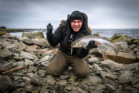 Happy man with big sea trout troph