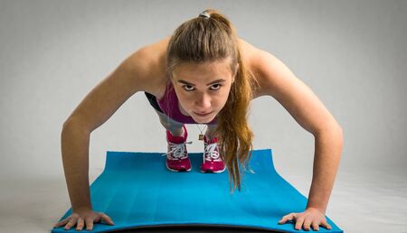 Girl under push ups training