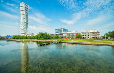 MALMO, SWEDEN - MAY 29, 2016: Turning Torso facade on May 29, Sweden. Turning Torso is a deconstructivist skyscraper designed by the Spanish architect Santiago Calatrava - wview with water reflection.のeditorial素材