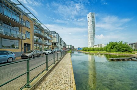MALMO, SWEDEN - MAY 29, 2016: Turning Torso facade on May 29, Sweden. Turning Torso is a deconstructivist skyscraper designed by the Spanish architect Santiago Calatrava - view with city buildings.のeditorial素材