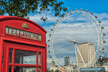 Iconic English telephone booth with London Eye in backgroundのeditorial素材