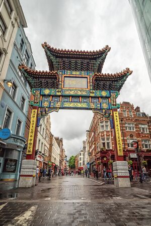 LONDON, UK - 12 JULY, 2016: Vertical view for entrance gate in Chinatown, London, UK. Chinatown features many restaurants, bakeries and souvenir shops near Gerrard Street in the Soho areaのeditorial素材