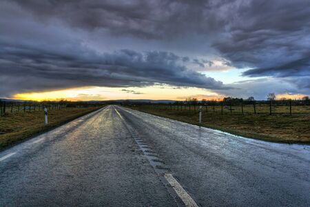 Dramatic sunset scenery over Swedish highwayの写真素材